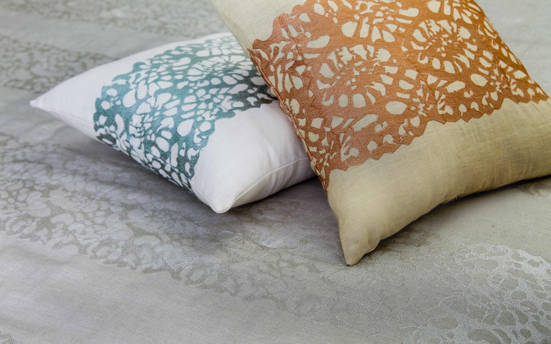Embroidered lace pillows on damask